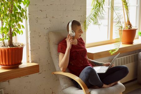 Happy Woman working from home during coronavirus or COVID-19 quarantine, remote office concept....
