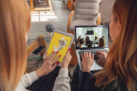 Best memories. Young friends, women using gadgets to watch cinema, photos, online courses, taking...