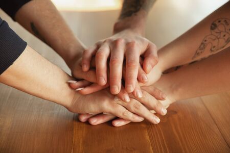 Close up of caucasian male and female hands, covering one another, shaking. Concept of business,...