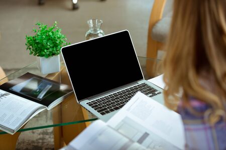 Young woman studying at home during online courses or free information by herself. Becomes musician,...