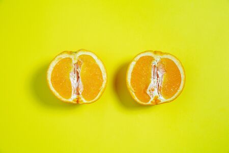 Oranges. Monochrome stylish and trendy composition in yellow color on studio background. Top view, flat lay. Pure beauty of usual things around. Copyspace for ad. Holiday, food, fashion.の写真素材