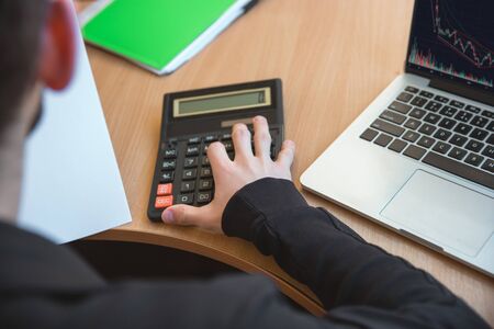 Counting, close up. Caucasian entrepreneur, businessman, manager working concentrated in office....