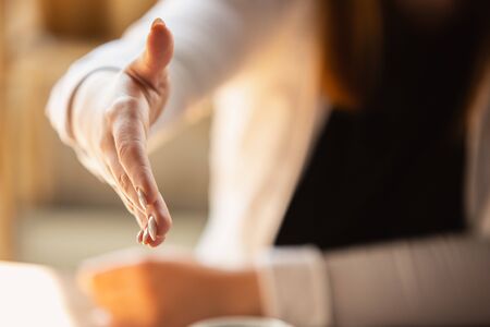 Greeting. Close up of caucasian female hands, working in office. Concept of business, finance, job, online shopping or sales. Copyspace for advertising. Education, communication freelance.の写真素材