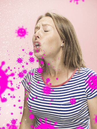 Caucasian woman sneezing, illustration of virus spreading, stop epidemic. Ill and fever, headache. Human emotions, sales, healthcare and medicine concept. Stop epidemic. Self-insulated, feels sick.の写真素材