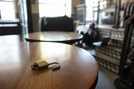 Restaurant, cafe, bar closed due to COVID-19 or Coronavirus outbreak lockdown, stressed owner of small business, depressed, despair. Businessman exhausted, upset. Business, economy, finance crisis.の写真素材