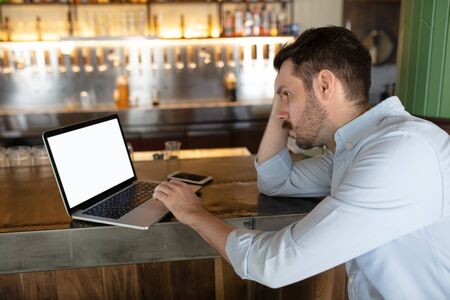 Restaurant, cafe, bar closed due to COVID-19 or Coronavirus outbreak lockdown, stressed owner of small business, depression. Businessman exhausted, upset. Business, economy, finance crisis.の写真素材