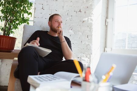 Young man studying at home during online courses for teacher, medical service manager. Getting...