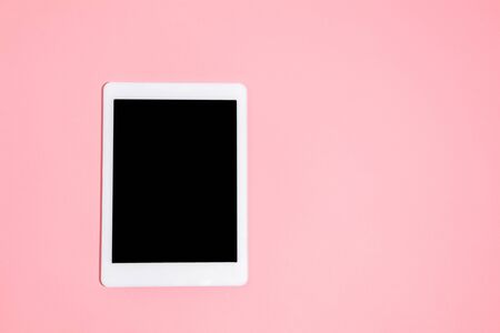 Gadgets, device on top view, blank screen with copyspace, minimalistic style. Technologies, modern, marketing. Negative space for ad. Coral on background. Stylish, trendy. Workplace for productivity.の写真素材