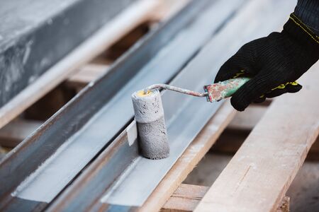 Closeup of repairman in uniform, professional builder working using construction equipment. Process...