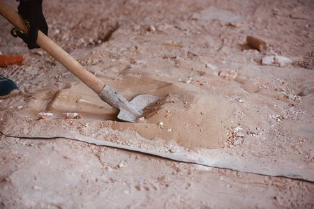 Closeup of repairman in uniform, professional builder working using construction equipment. Process...