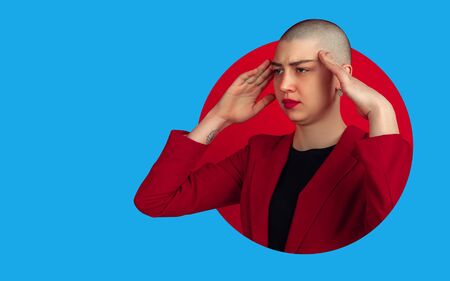 Portrait of young woman with freaky look on bright bicolor background with geometric style. Beautiful female model thoughtful. Human emotions, facial expression, sales, ad concept. Artwork, design.の写真素材