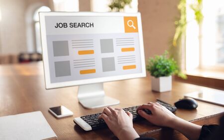 Woman looking for a job during worldwide crisis. Find a job online. Business, internet and networking concept. Woman looks through vacancies and sends resumes, needs to earn. Modern digital search bar.の写真素材