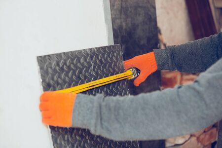Closeup of professional builder working using construction equipment.の写真素材