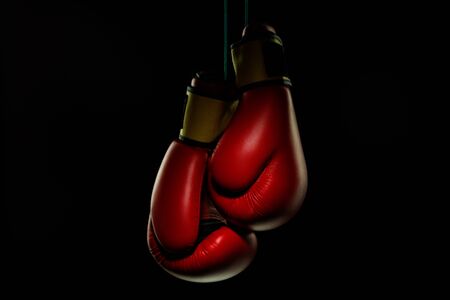 Boxers red gloves.. Professional sport equipment isolated on black studio background. Concept of sport, leadership, competition, healthy lifestyle in motion and action, training. Close up, copyspace.の写真素材