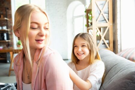 Mother and daughter, sisters have quite, beauty and fun day together at home. Comfort and togetherness. Concept of childhood, happiness, familys weekend, friendship, pajamas party. Domestic lifestyle.の写真素材
