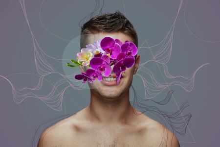 Portrait of beautiful man with modern floral design, inspiration artwork. Beauty, fashion and ad concept. Fashionable and contemporary look, tiny and tender flowers. Spring, flower blooming beauty.の写真素材
