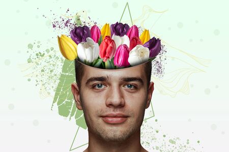 Portrait of beautiful man with modern floral design, inspiration artwork. Beauty, fashion and ad concept. Fashionable and contemporary look, tiny and tender flowers. Spring, flower blooming beauty.の写真素材