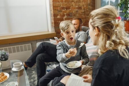 Happy family at home spending time together. Having fun, look cheerful and lovely. Mother, father...