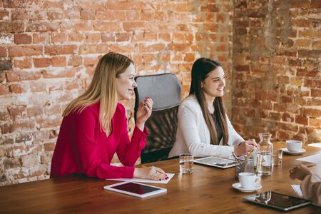 Discussion. Young business woman in modern office with team. Creative meeting, tasks giving. Women...