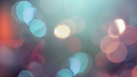 Multicolored defocused bokeh lights background - horizontal wallpaper, poster. Stylish, festive and elegance shot. Trendy colors. Illuminated, lights, glitter effects. Celebrative decoration.の写真素材