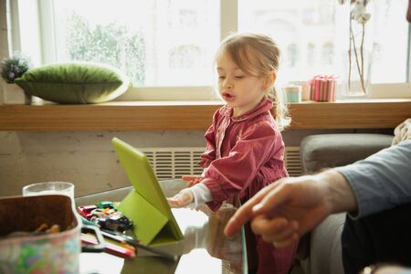 Grandfather and grandchild playing together at home. Happiness, family, relathionship, learning and...