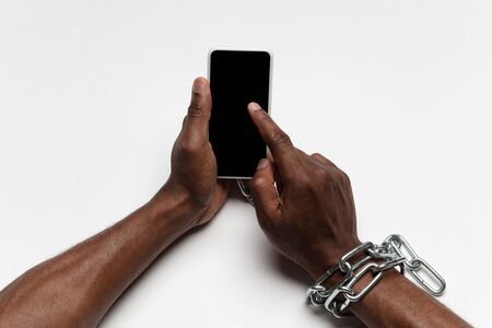 Close up of human hands using smartphone isolated on white background. Top view. Copyspace, blank...