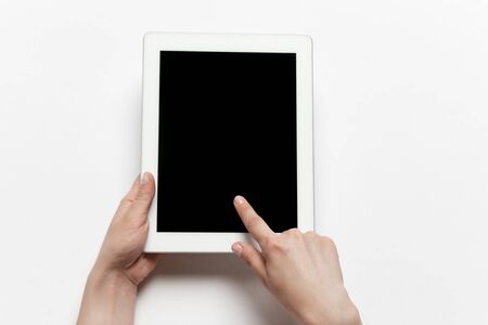 Close up of human hands using tablet isolated on white background. Top view. Copyspace, blank...