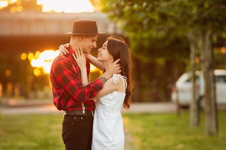 Caucasian young couple enjoying weekend together in the park on summer day.
