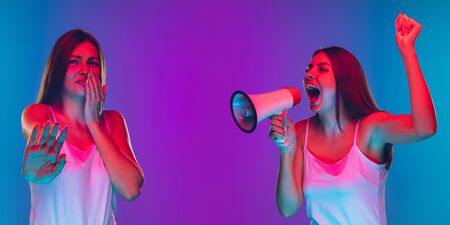 Shouting with megaphone. Caucasian young womans portrait on blue background in neon light. Beautiful model in casual. Concept of human emotions, facial expression, sales, ad. Flyer with copyspace.の写真素材
