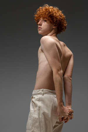 Classy. Fashion portrait of beautiful redhead man isolated on grey studio background. Concept of beauty, skin care, fashion and style. Artwork, modern and trendy portrait. Attractive model.の写真素材