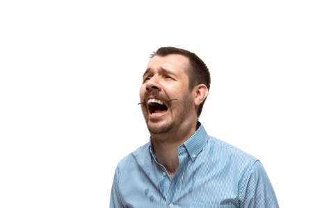 Pain, screaming. Young man with funny, unusual popular emotions and gestures isolated on white...