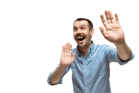 Dancing. Young man with funny, unusual popular emotions and gestures isolated on white studio background. Human emotions, facial expression, sales, ad concept. Trendy look inspired by memes.の写真素材