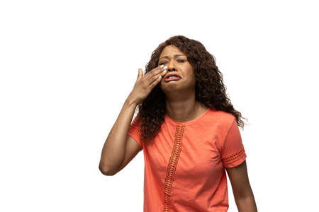 Crying. Young african-american woman with funny, unusual popular emotions and gestures on white...