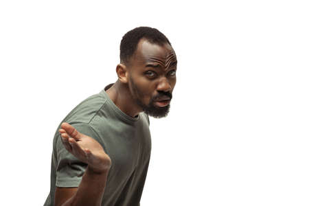 WHAT. Young african-american man with funny, unusual popular emotions and gestures on white studio...