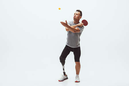 Athlete with disabilities or amputee isolated on white studio background. Professional male table...