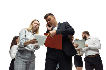 Strained. Nervous tensioned investors analyzing crisis stock market with charts on their gadgets....