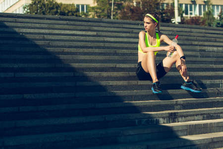 Taking a breathe. Female runner, athlete training outdoors. Professional runner, jogger working out...
