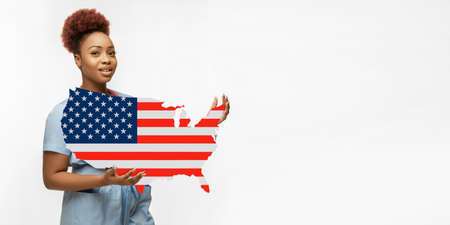 Beautiful african-american doctor cares about USA isolated over white studio background. Copyspace. Concept of healthcare and medicine, taking care, treatment during coronavirus outbreak, pandemic.の写真素材