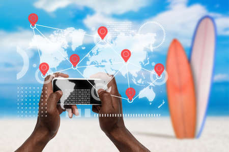 Food and goods purchase via the Internet anywhere you go. Your smartphone or other gadget - all you need for ordering to any address. Hands holding smartphone with interactive map of delivery points.の写真素材