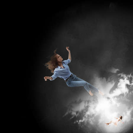 Mid-air beauty cought in moment. Full length shot of attractive young woman hovering in air and...