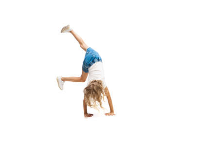 Energy. Happy kids, little and emotional caucasian girl jumping and running isolated on white...