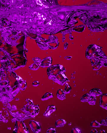 Close up view of the cold and fresh cola with bright bubbles in neon light. Texture of cooling...
