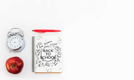 Colorful school supplies corner border over a white background with words Back to school. Pencils, paints, scissors, stickers. Education, school time, childhood concept. Copyspace, ready for ad.の写真素材