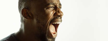 Crying. African-american young mans close up shot on studio background, flyer. Concept of human...