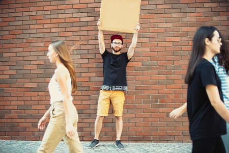 Dude with sign - man stands protesting things that annoy him. Solo demonstration his right to talk...