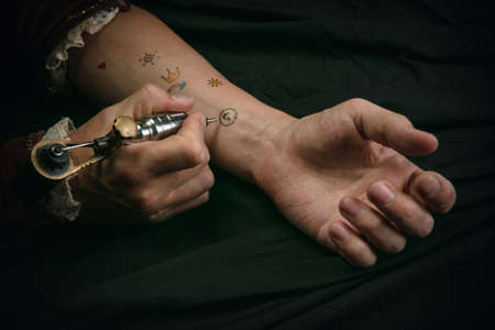Making tattoo. Young man as Johann Bach isolated on dark green background. Retro style, comparison...