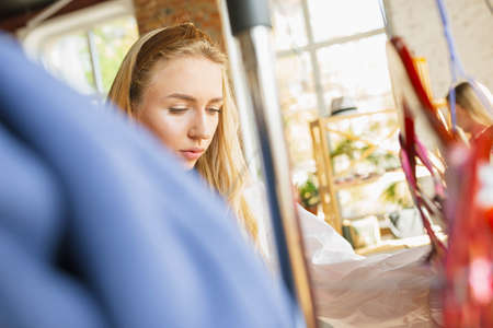 Wear, clothing shop during sales, summer or autumn collection. Young woman choosing, looking for new...