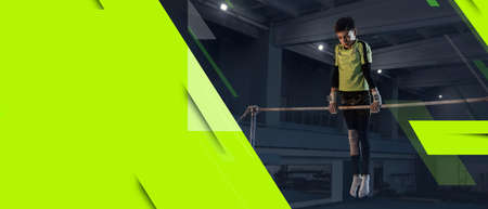 Little male athlete training in gym, doing strength exercises, practicing. Sportsman works on her...
