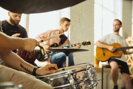 Festival. Musician band jamming together in art workplace with instruments. Caucasian men and women,...