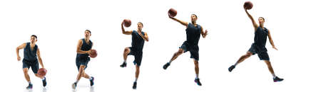 Winner. Young basketball player of team training in action, motion in jump of step-to-step goal isolated on white background. Concept of sport, movement, energy and dynamic, healthy lifestyle.の写真素材
